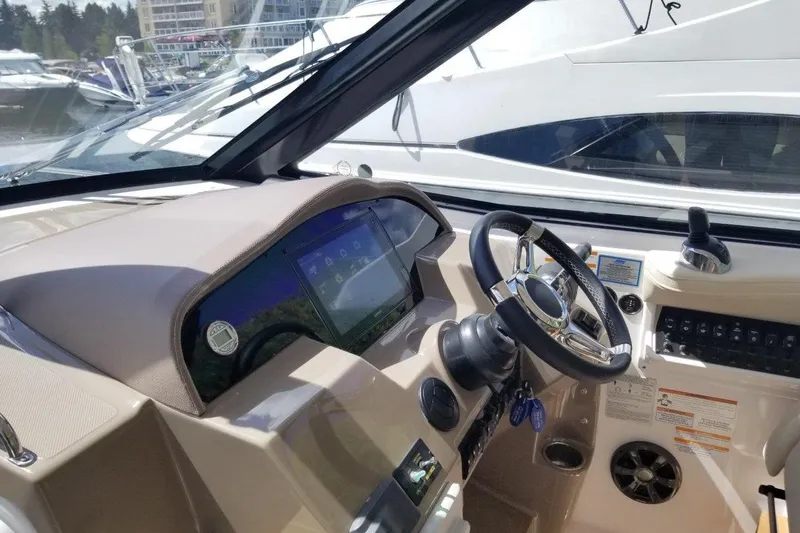 Ships N Giggles Yacht Photos Pics Cockpit of 2018 Regal 35 Sport Coupe with modern steering and control panel.