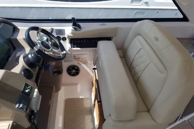 Ships N Giggles Yacht Photos Pics 2018 Regal 35 Sport Coupe helm with beige leather seating and modern controls.