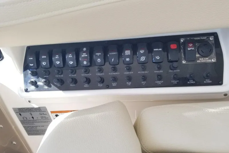 Ships N Giggles Yacht Photos Pics Control panel of a 2018 Regal 35 Sport Coupe boat with various switches and labels.