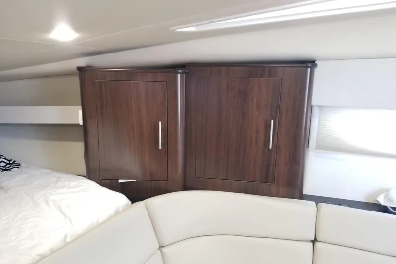 Ships N Giggles Yacht Photos Pics Interior of 2018 Regal 35 Sport Coupe with wooden cabinets and white seating.