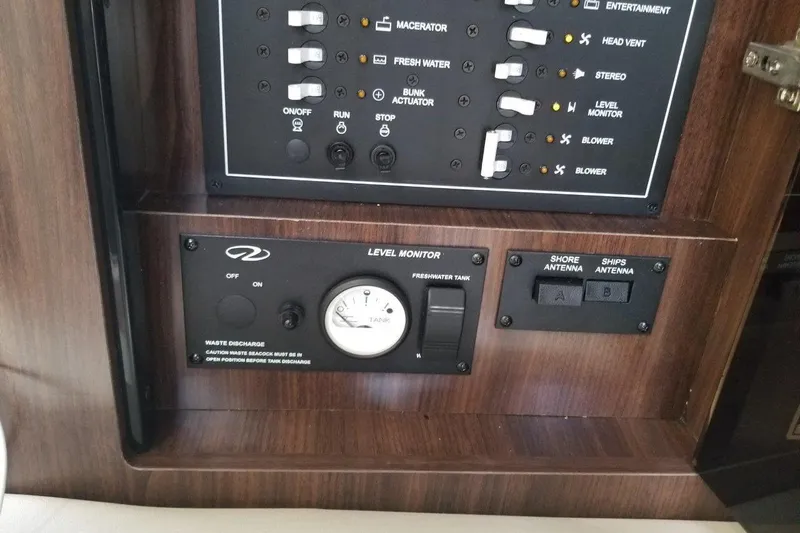 Ships N Giggles Yacht Photos Pics Control panel of a 2018 Regal 35 Sport Coupe with level monitor and switches.