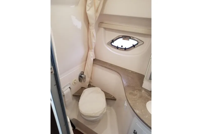Ships N Giggles Yacht Photos Pics 2018 Regal 35 Sport Coupe bathroom with compact design and porthole window.