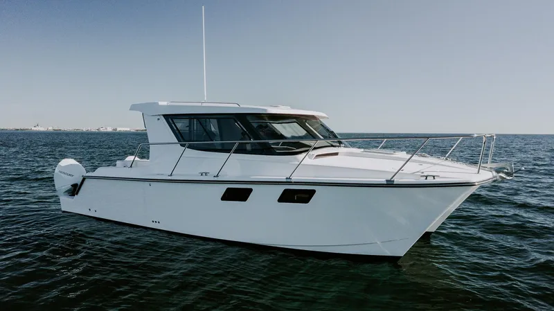  Yacht Photos Pics 2025 ArrowCat 320 boat cruising on open water under clear skies.