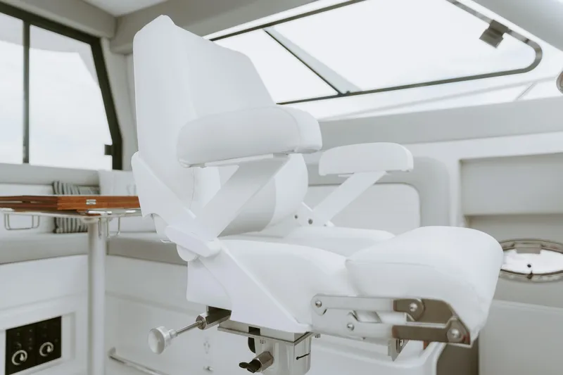  Yacht Photos Pics Luxurious white captain's chair in 2025 ArrowCat 320 boat interior.