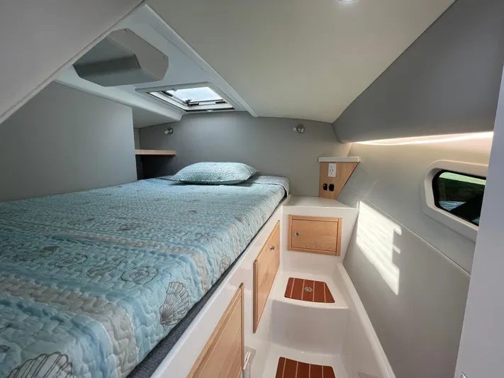  Yacht Photos Pics Cozy cabin interior of 2025 ArrowCat 320 with bed, skylight, and storage.
