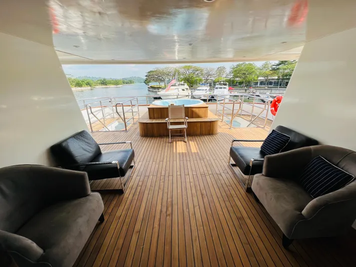  Yacht Photos Pics Luxurious 2012 Superyacht 128 deck with elegant seating and scenic marina view.