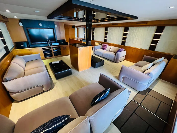  Yacht Photos Pics Luxurious interior of 2012 Superyacht 128, featuring plush seating and modern entertainment system.