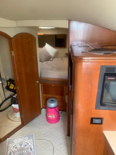 Reel Project Yacht Photos Pics Interior of 2006 Rampage 38 Express boat with wood cabinetry and cozy sleeping area.