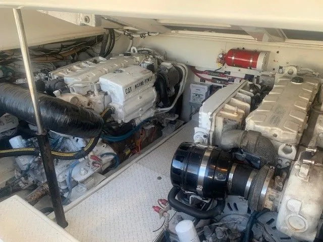 Reel Project Yacht Photos Pics Engine room of a 2006 Rampage 38 Express boat, featuring dual Caterpillar marine engines.