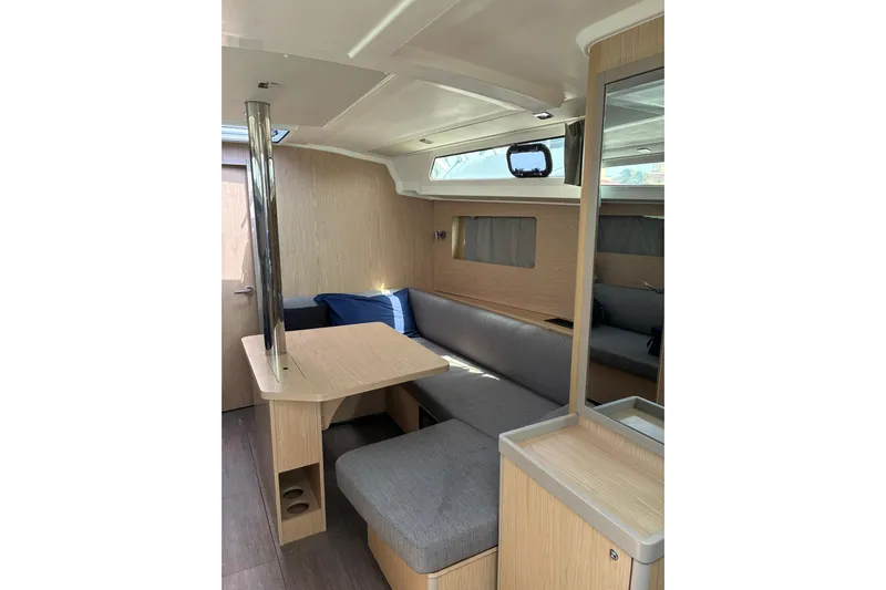 Yacht Photos Pics Interior of 2020 Beneteau Oceanis 41.1 yacht with modern seating and wooden finishes.