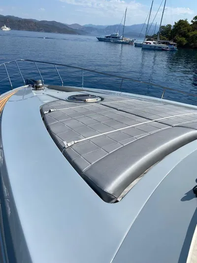  Yacht Photos Pics 2009 Pershing 64 yacht with sunpad, docked in serene waters.