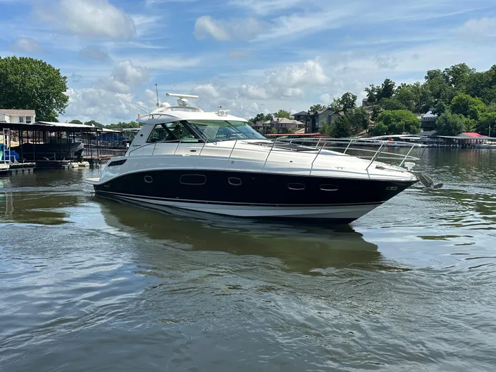  Yacht Photos Pics 2010 Sea Ray 450 Sundancer yacht cruising on a calm lake.