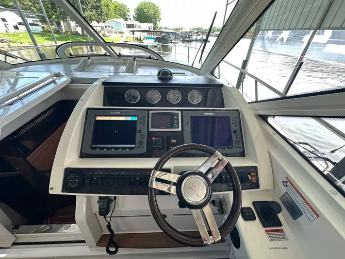  Yacht Photos Pics Helm of 2010 Sea Ray 450 Sundancer with modern navigation equipment and steering wheel.