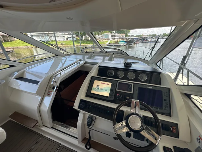  Yacht Photos Pics Interior view of 2010 Sea Ray 450 Sundancer yacht cockpit with modern navigation equipment.