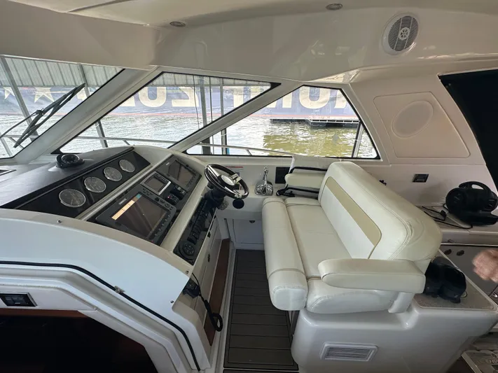  Yacht Photos Pics Interior view of 2010 Sea Ray 450 Sundancer yacht cockpit with steering wheel and seating.