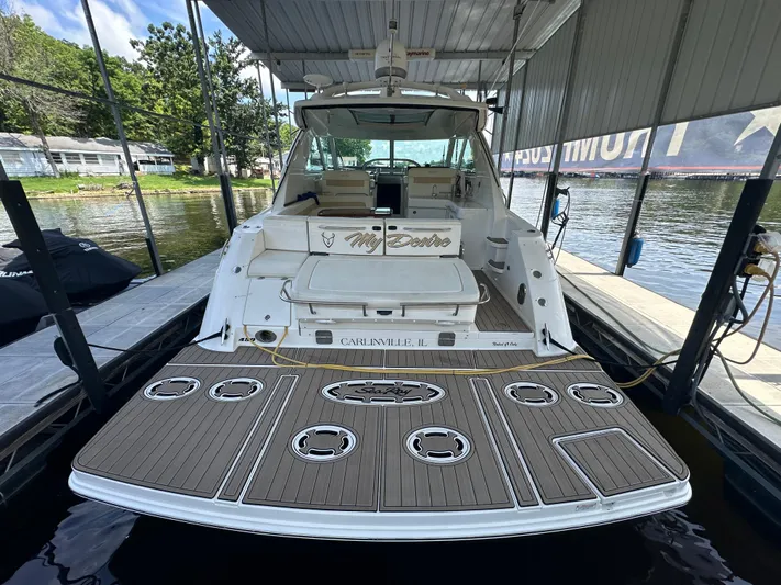  Yacht Photos Pics 2010 Sea Ray 450 Sundancer docked, featuring spacious deck and luxurious seating.