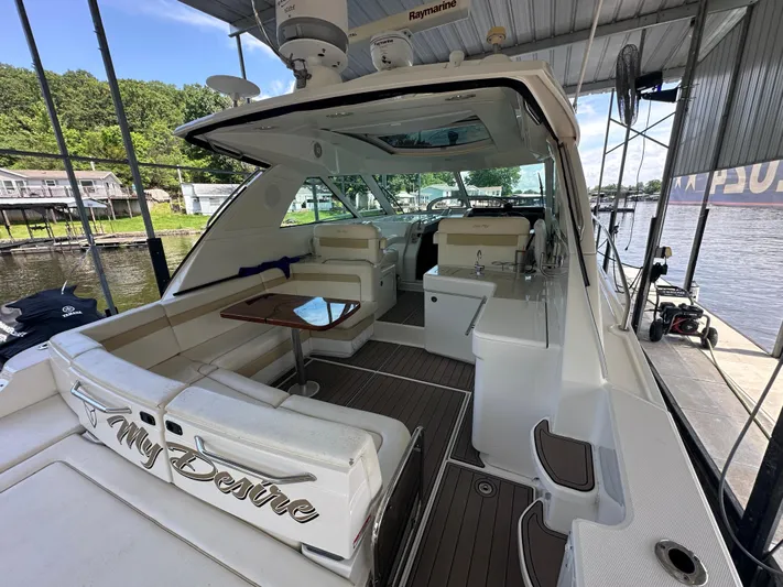 Yacht Photos Pics 2010 Sea Ray 450 Sundancer yacht with spacious deck and seating, docked at marina.