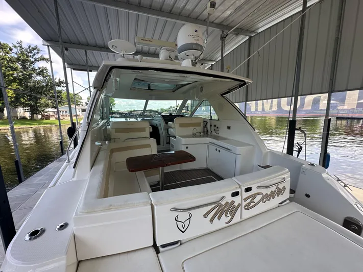  Yacht Photos Pics 2010 Sea Ray 450 Sundancer yacht docked under a covered marina.