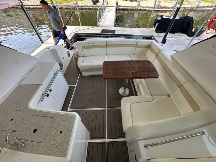  Yacht Photos Pics 2010 Sea Ray 450 Sundancer yacht interior with seating and table, dockside view.