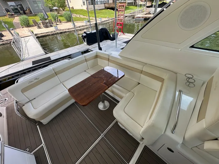 Yacht Photos Pics Luxurious seating area on 2010 Sea Ray 450 Sundancer yacht with wooden table.