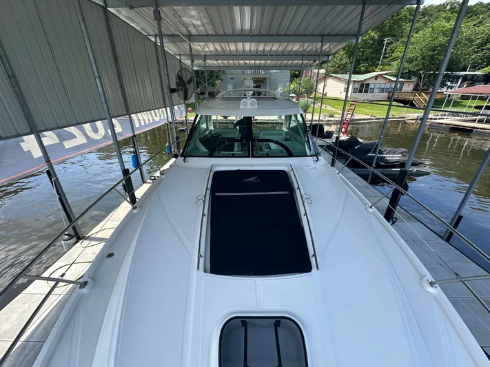  Yacht Photos Pics 2010 Sea Ray 450 Sundancer docked under a covered marina, showcasing sleek design.