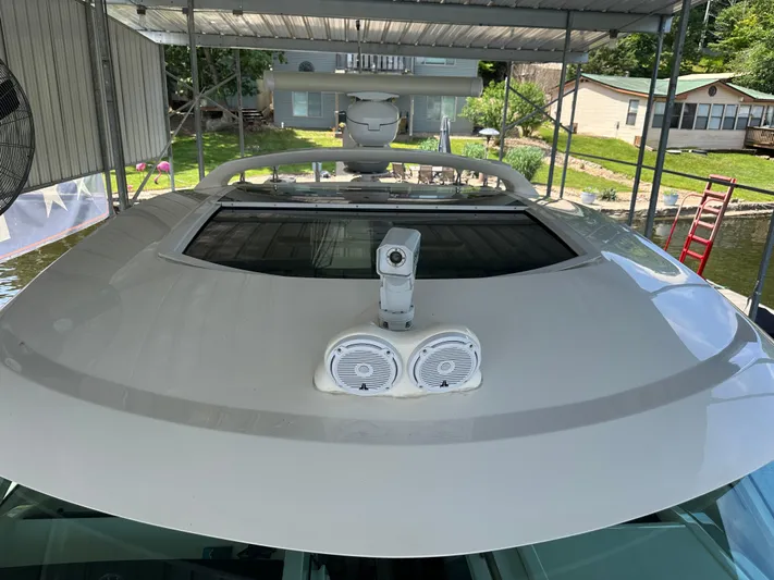  Yacht Photos Pics 2010 Sea Ray 450 Sundancer yacht under covered dock, featuring radar and lights.