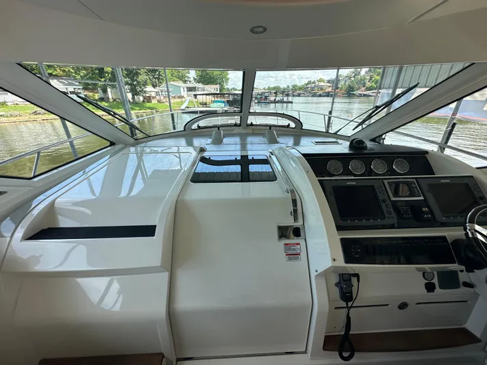  Yacht Photos Pics Helm of 2010 Sea Ray 450 Sundancer yacht with navigation controls and waterfront view.