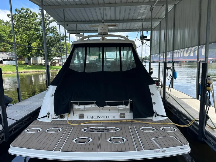  Yacht Photos Pics 2010 Sea Ray 450 Sundancer docked under a covered marina, rear view.