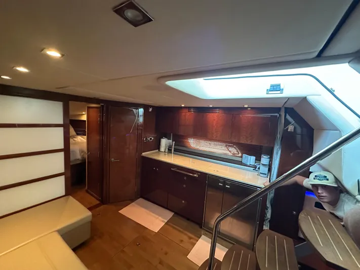  Yacht Photos Pics Luxurious interior of 2010 Sea Ray 450 Sundancer yacht with modern kitchen and seating area.