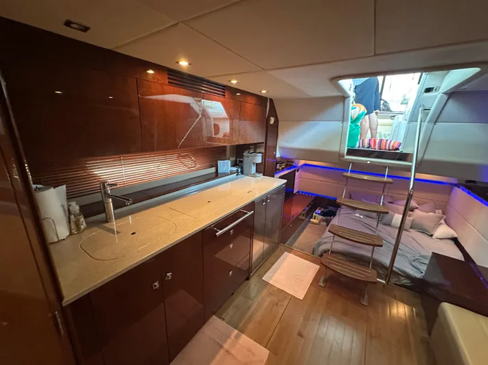  Yacht Photos Pics Luxurious interior of 2010 Sea Ray 450 Sundancer yacht with modern kitchen and cozy seating area.