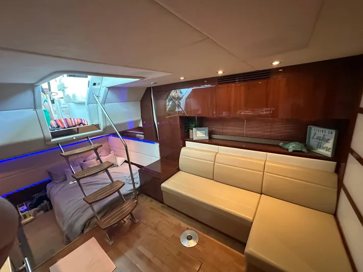  Yacht Photos Pics Luxurious interior of 2010 Sea Ray 450 Sundancer yacht with modern seating and cozy sleeping area.