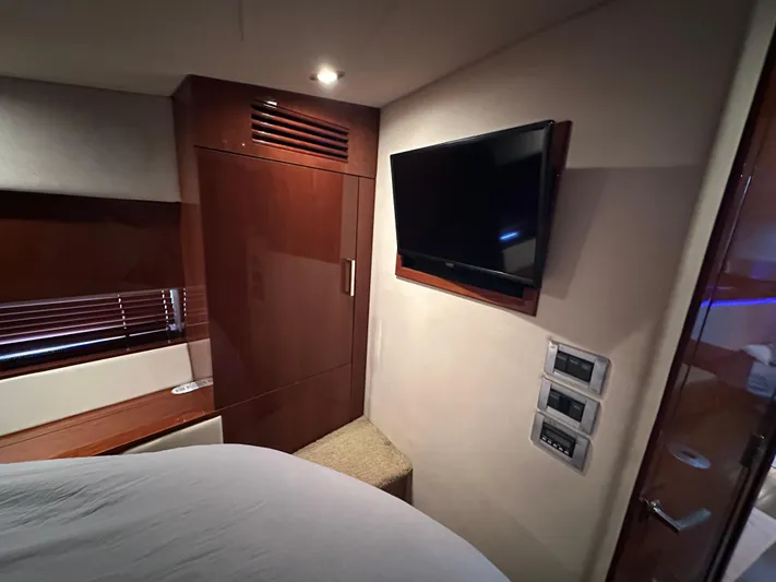  Yacht Photos Pics Interior cabin of 2010 Sea Ray 450 Sundancer with TV and wooden cabinetry.