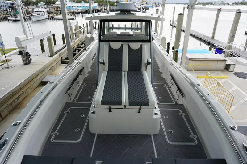 Obsession II Yacht Photos Pics 2023 Insetta 35IFC boat interior with sleek seating and modern design at a marina.