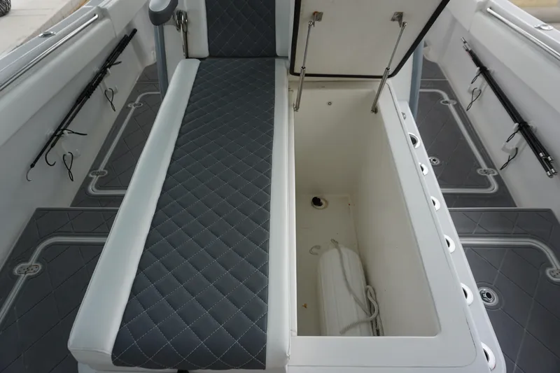 Obsession II Yacht Photos Pics 2023 Insetta 35IFC boat interior with open storage compartment and cushioned seating.