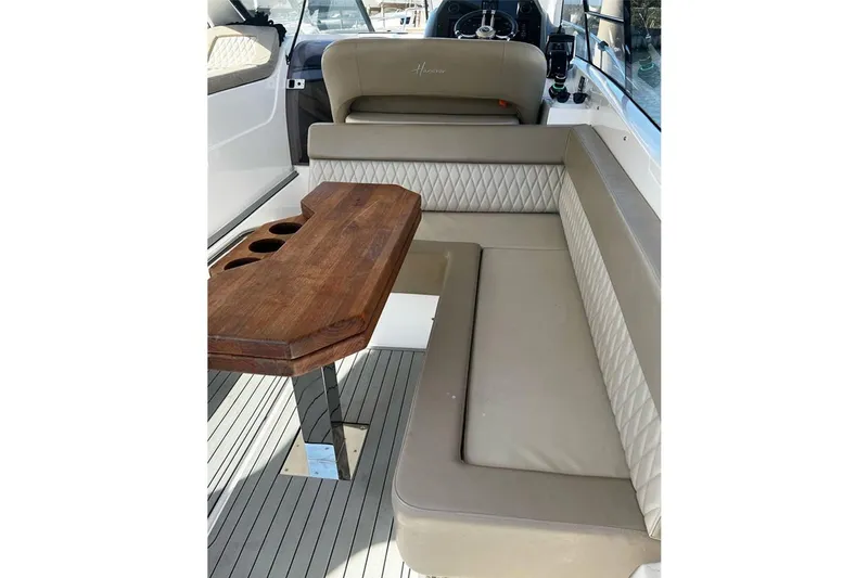  Yacht Photos Pics Luxurious interior of 2024 Hanover 375 boat with elegant seating and wooden table.