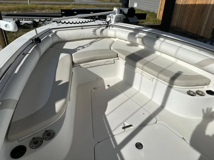  Yacht Photos Pics 2004 Boston Whaler 32 Outrage boat interior with cushioned seating and fishing rod holders.