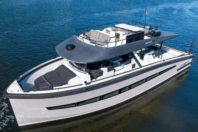  Yacht Photos Pics 2019 DutchCraft 56 Open yacht on calm water, showcasing sleek design and spacious deck.