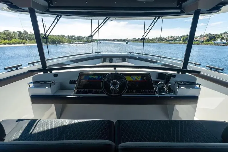  Yacht Photos Pics Cockpit view of 2019 DutchCraft 56 Open yacht, featuring modern navigation controls and scenic waterway.
