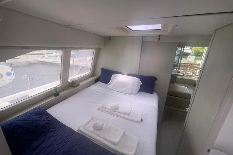  Yacht Photos Pics Luxurious cabin interior of 2015 Leopard 58 yacht with bed and marina view.