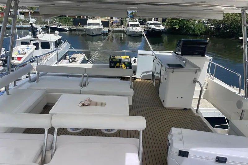  Yacht Photos Pics Luxurious 2015 Leopard 58 yacht deck with seating, kitchenette, and scenic marina view.