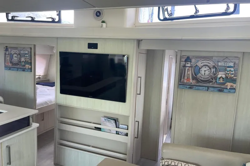  Yacht Photos Pics Interior of a 2015 Leopard 58 yacht with modern decor and wall-mounted TV.