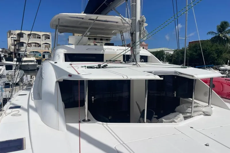  Yacht Photos Pics Leopard 58 catamaran docked at marina, 2015 model, sunny day, clear blue sky.