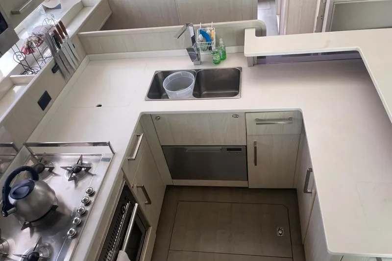  Yacht Photos Pics Modern kitchen in a 2015 Leopard 58 yacht with stove, sink, and ample counter space.