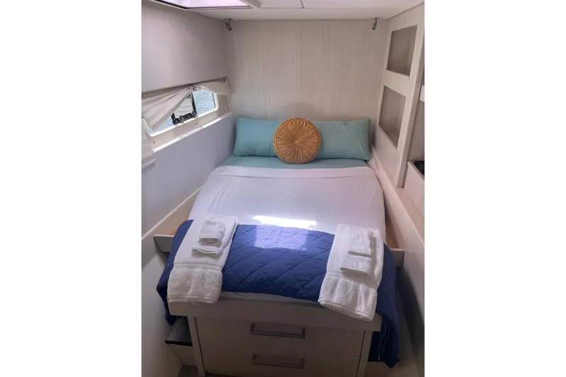  Yacht Photos Pics Cozy bedroom in 2015 Leopard 58 yacht with neatly arranged bed and window view.
