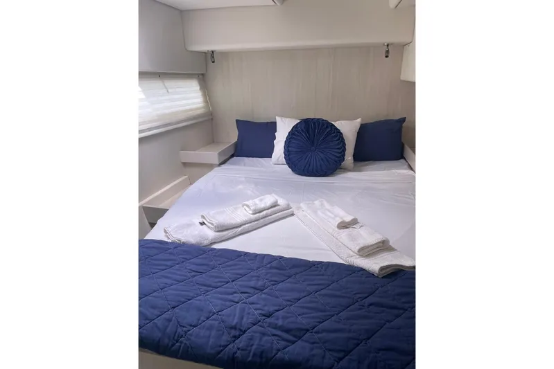  Yacht Photos Pics Luxurious bedroom in 2015 Leopard 58 yacht with blue accents and neatly arranged towels.
