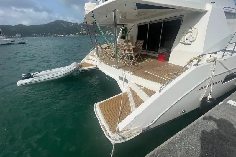  Yacht Photos Pics Luxury Leopard 58 yacht docked, featuring spacious deck and tender boat, 2015 model.