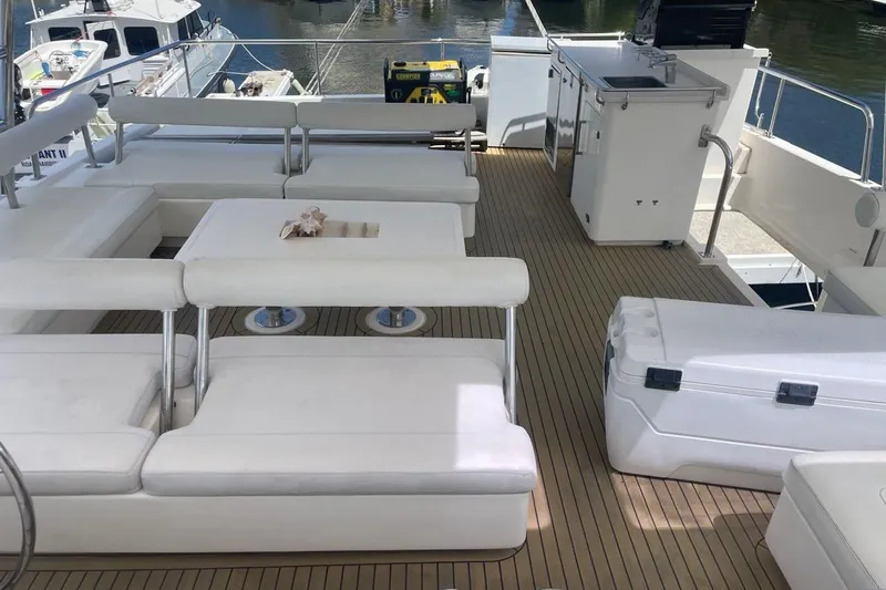  Yacht Photos Pics Luxurious 2015 Leopard 58 yacht deck with white seating and kitchenette.