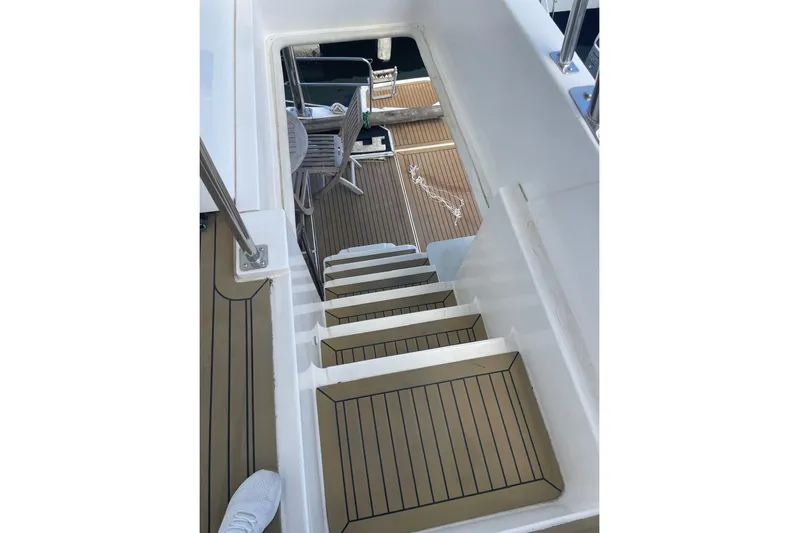  Yacht Photos Pics Staircase on a 2015 Leopard 58 yacht, leading to a wooden deck area.