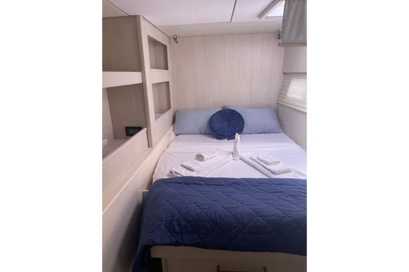  Yacht Photos Pics Cozy bedroom in 2015 Leopard 58 yacht with blue bedding and decorative pillows.