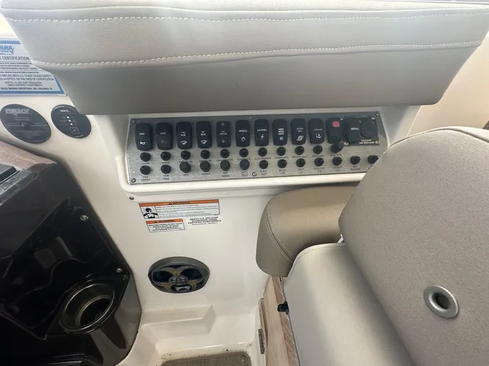 Panacea Yacht Photos Pics Control panel of a 2015 Regal 35 Sport Coupe boat with switches and buttons.